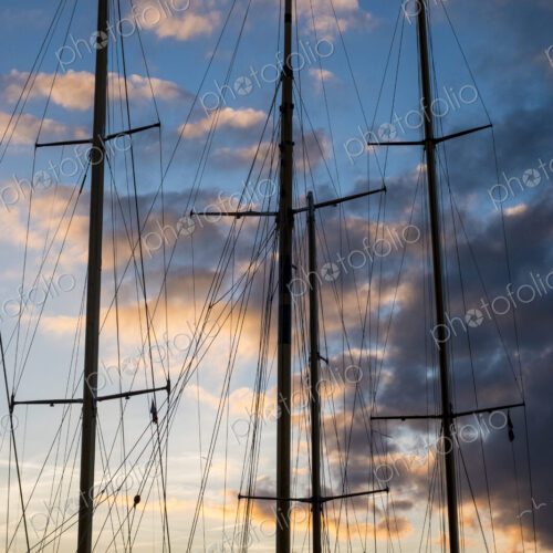 Sailing ship masts and rigging against a cloudy sky at sunset. Sailing ship masts and rigging against a cloudy sky at sunset.