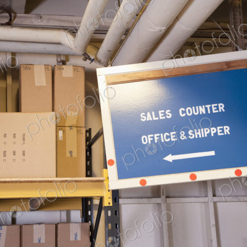 Sales counter sign and cardboard boxes on shelf in warehouse. Sales counter sign and cardboard boxes on shelf in warehouse.