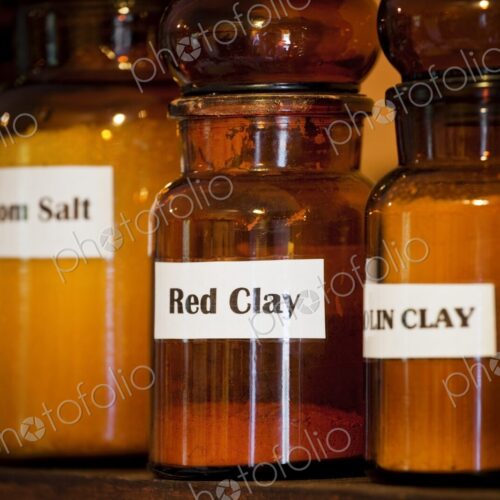 Salts and minerals, used for natural healing, on a shelf in an apothecary shop.