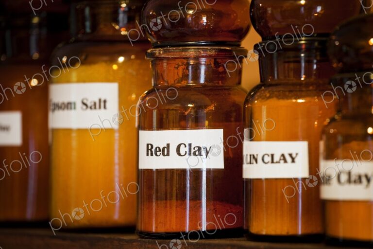 Salts and minerals, used for natural healing, on a shelf in an apothecary shop.