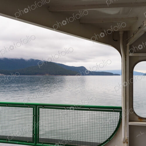 San Juan Islands ferry, a view from the deck of islands and calm water. San Juan Islands ferry, a view from the deck of islands and calm water.