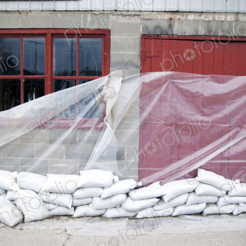 Sandbags and glass sheet on building wall Sandbags and glass sheet on building wall