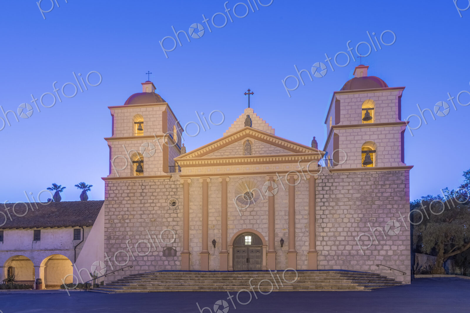 Santa Barbara mission, an 18th century Spanish colonial style church building at dusk,…