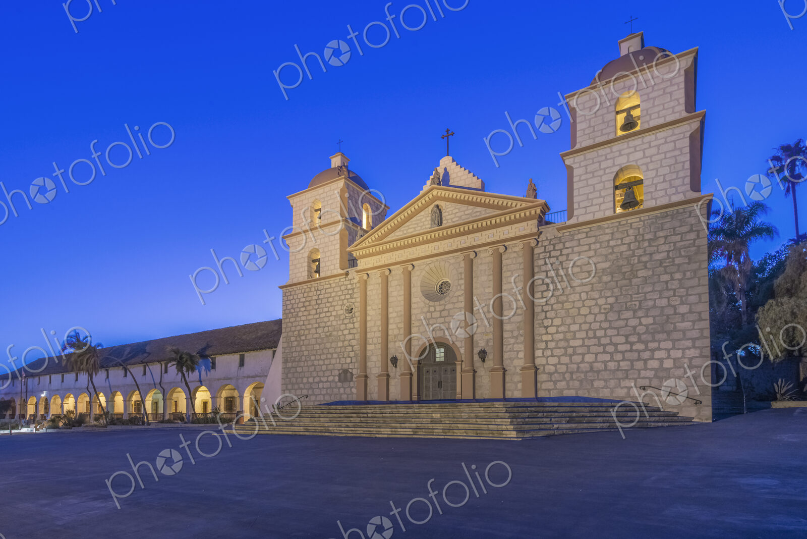 Santa Barbara mission, an 18th century Spanish colonial style church building at dusk,…