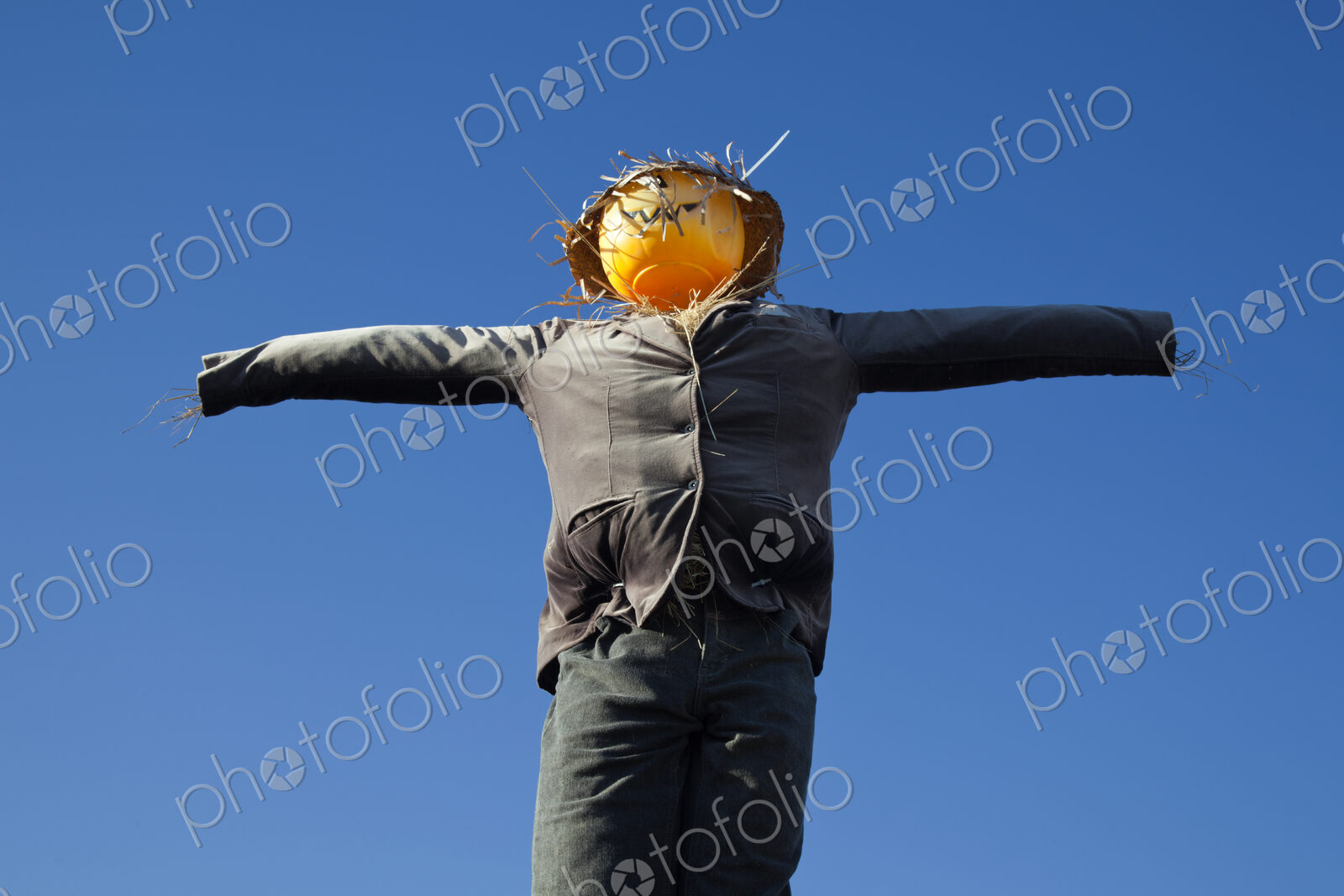 Scarecrow against blue sky