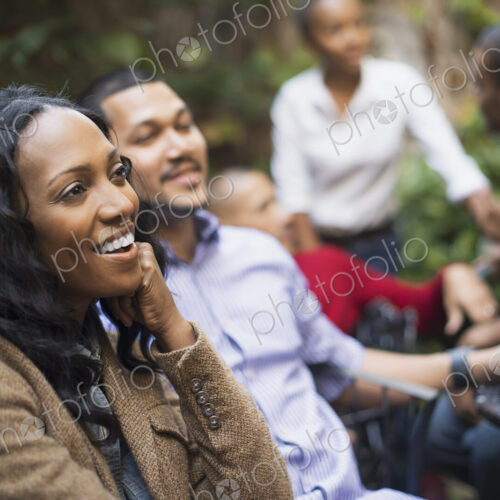 Scenes from urban life in New York City. A group of friends sitting together in a… Scenes from urban life in New York City. A group of friends sitting together in a…