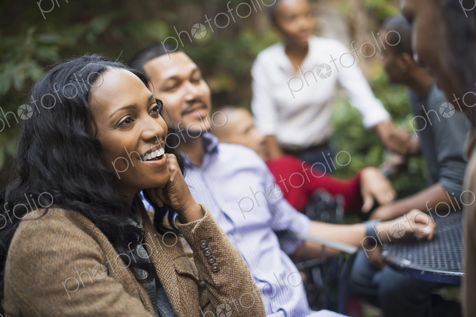 Scenes from urban life in New York City. A group of friends sitting together in a…