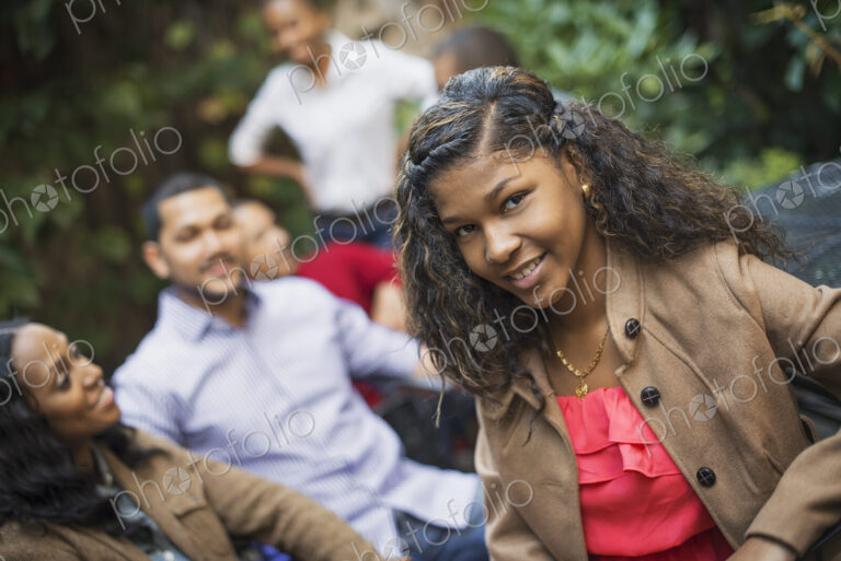Scenes from urban life in New York City. A group of friends sitting together in a…
