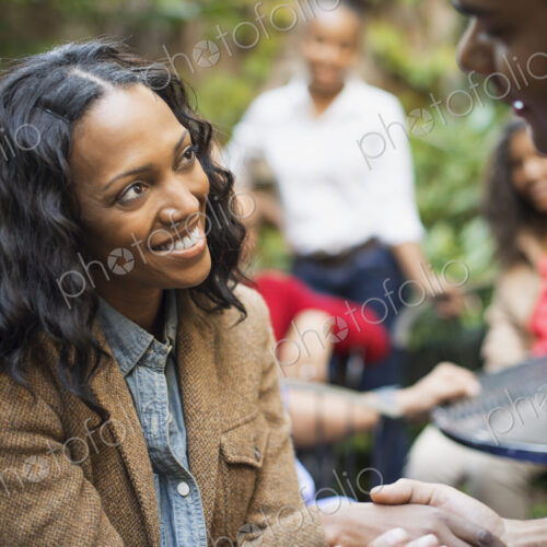 Scenes from urban life in New York City. A group of friends sitting together in a… Scenes from urban life in New York City. A group of friends sitting together in a…