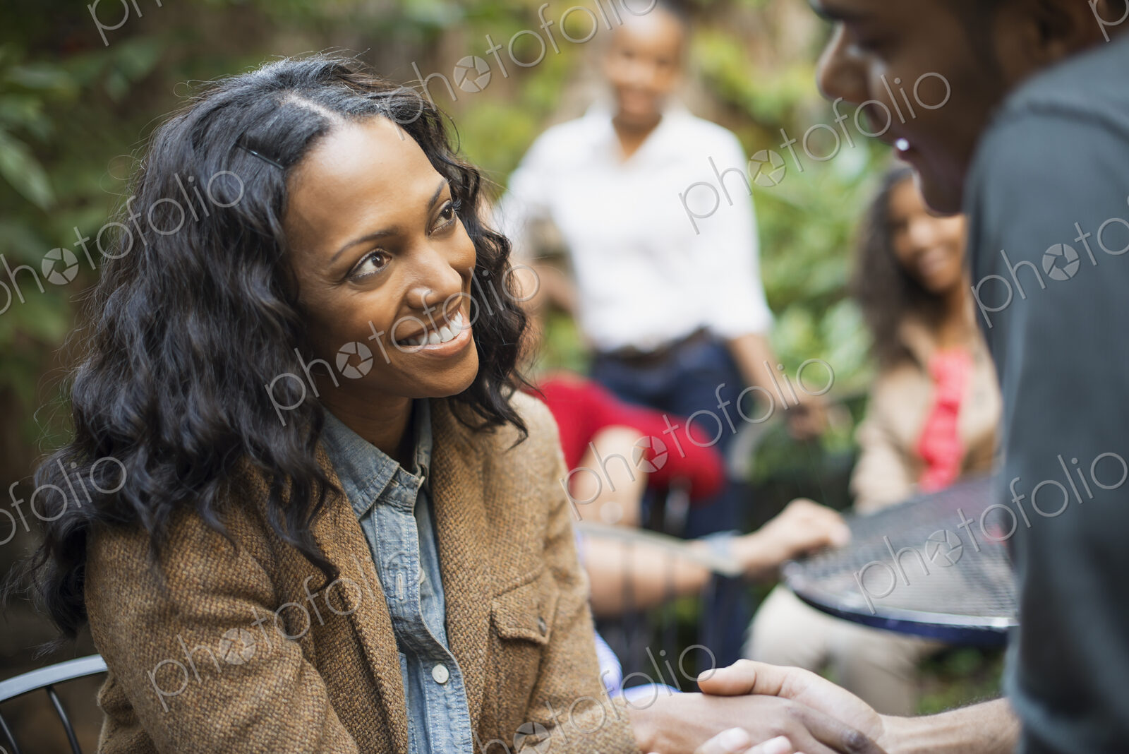 Scenes from urban life in New York City. A group of friends sitting together in a…