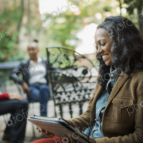 Scenes from urban life in New York City. A group of people sitting on a terrace… Scenes from urban life in New York City. A group of people sitting on a terrace…