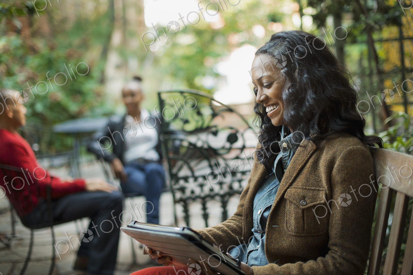 Scenes from urban life in New York City. A group of people sitting on a terrace…