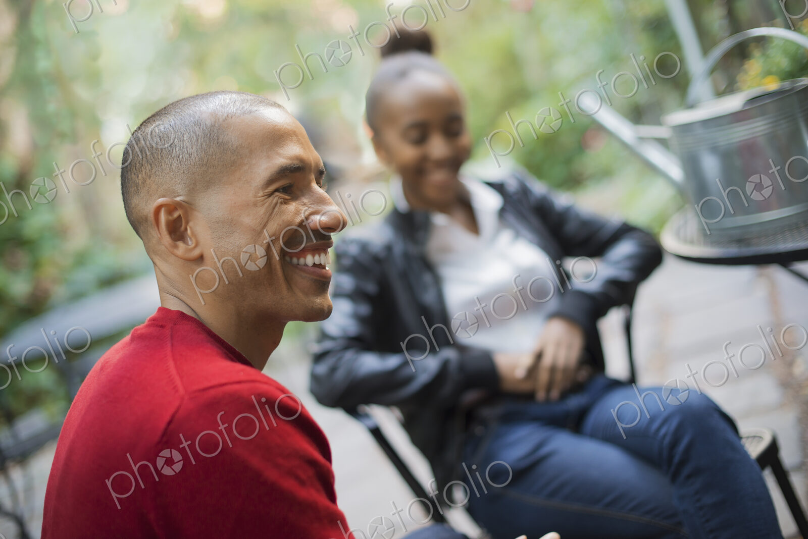 Scenes from urban life in New York City. A man and a teenage girl sitting outdoors.…