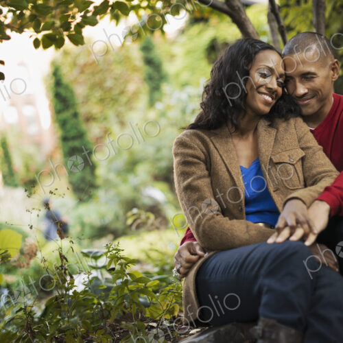 Scenes from urban life in New York City. A man and a woman, a couple sitting close… Scenes from urban life in New York City. A man and a woman, a couple sitting close…