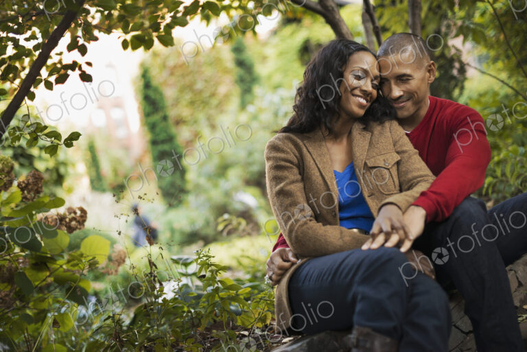 Scenes from urban life in New York City. A man and a woman, a couple sitting close…