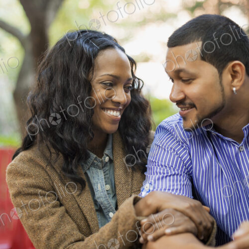 Scenes from urban life in New York City. A man and a woman, a couple with linked arms…