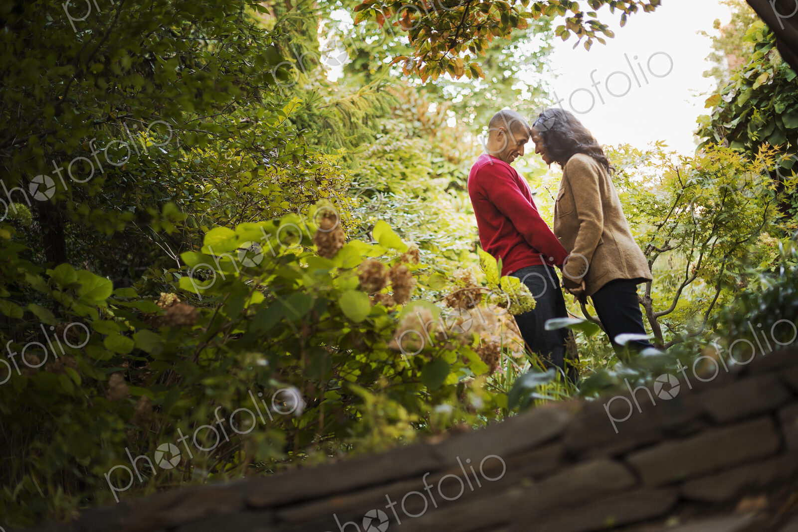Scenes from urban life in New York City. A park with trees. A man and a woman, a…