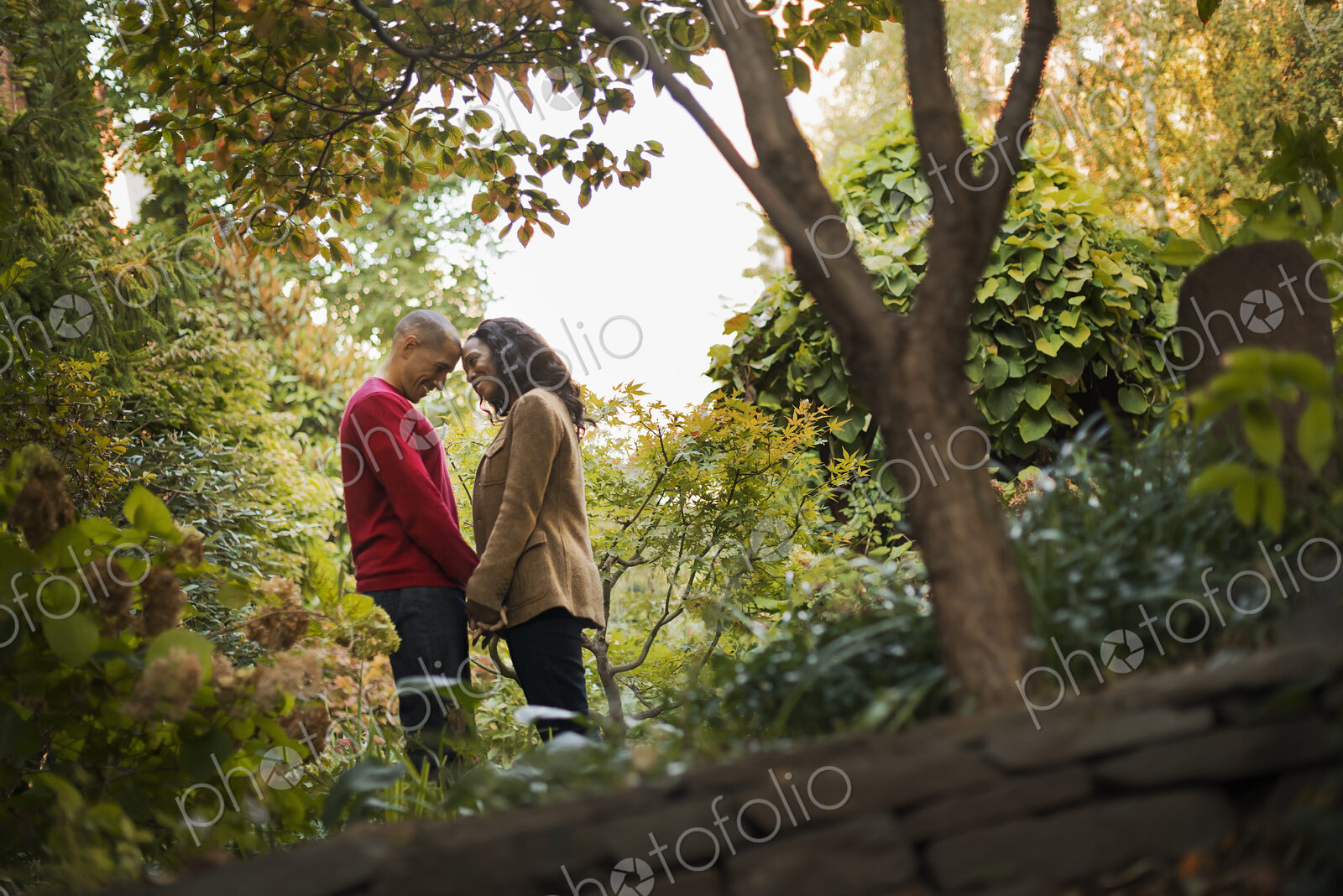 Scenes from urban life in New York City. A park with trees. A man and a woman, a…