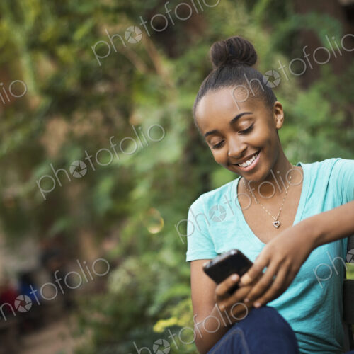 Scenes from urban life in New York City. A young teenage girl sitting on a bench,… Scenes from urban life in New York City. A young teenage girl sitting on a bench,…