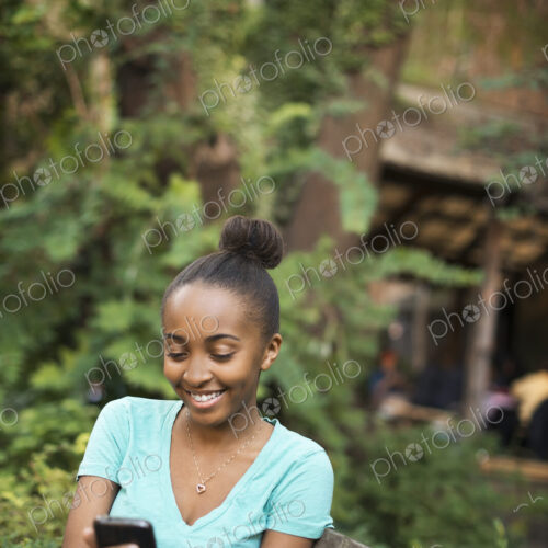 Scenes from urban life in New York City. A young teenage girl sitting on a bench,… Scenes from urban life in New York City. A young teenage girl sitting on a bench,…