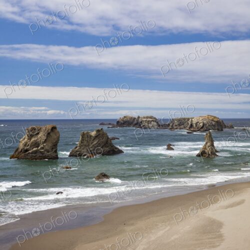 Scenic view of sea stacks rising from the Pacific Ocean along the sandy shoreline of… Scenic view of sea stacks rising from the Pacific Ocean along the sandy shoreline of…
