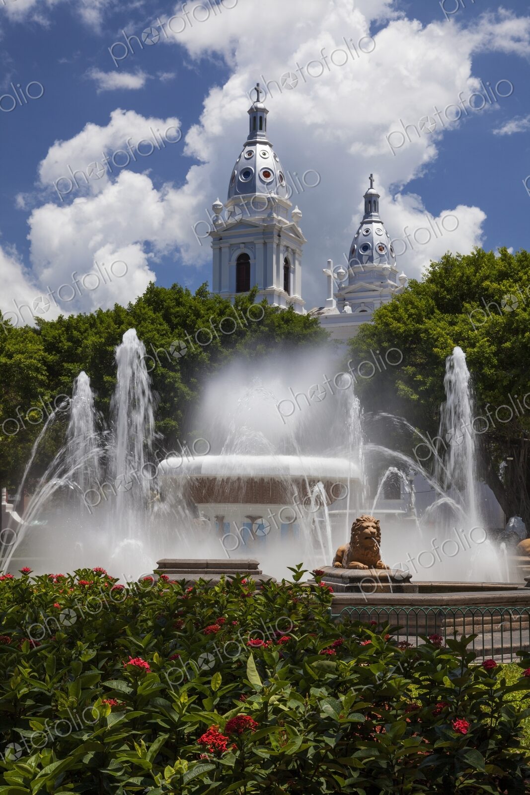 Scenic view of the Fountain of the Lions with the twin towers of the historic Ponce…
