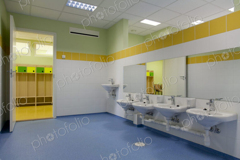 School Restroom, modern style with yellow paint and blue flooring