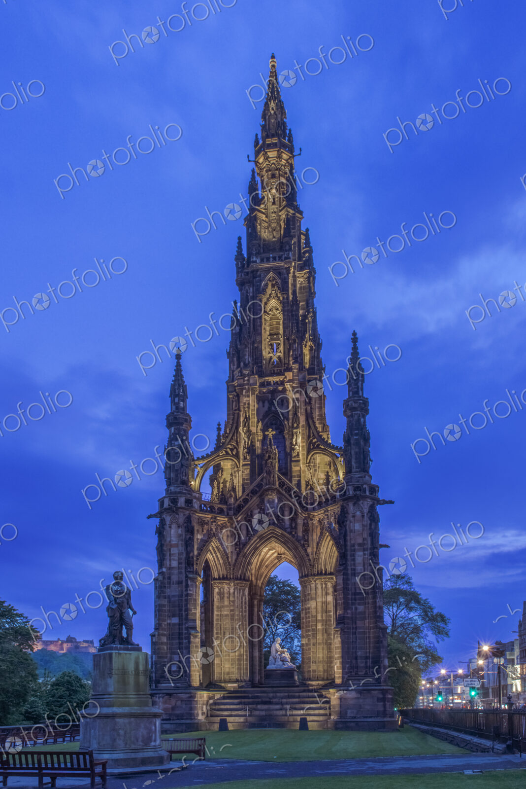 Scott Monument gothic constrution lit up at dusk.