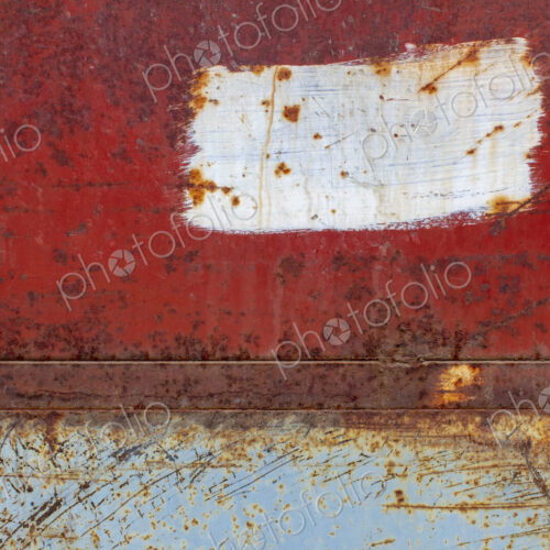 Scratch and rust markings on old metal wall