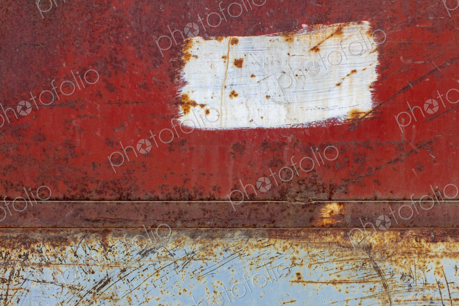 Scratch and rust markings on old metal wall
