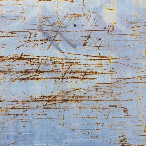 Scratch and rust markings on old metal wall
