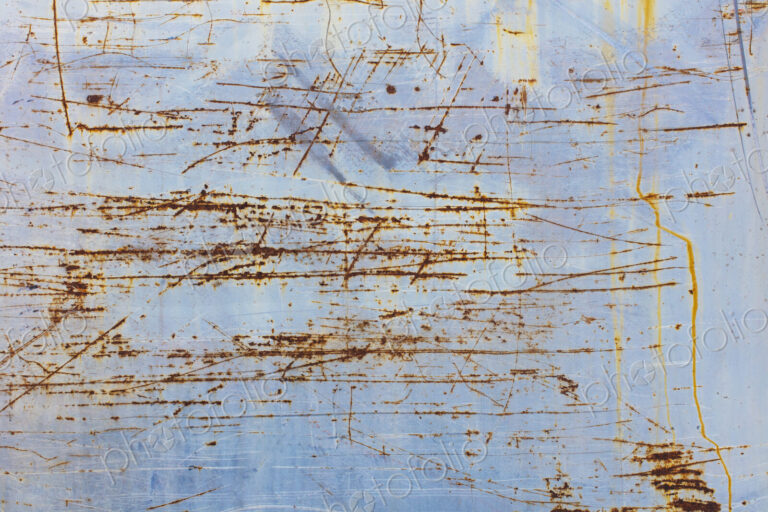Scratch and rust markings on old metal wall