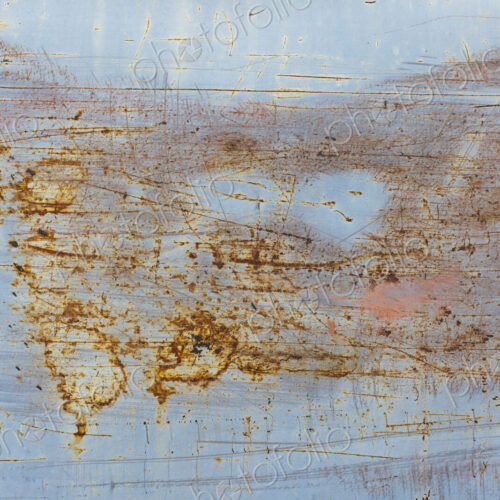 Scratch and rust markings on old metal wall