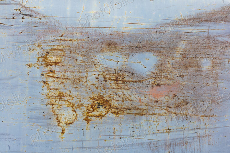 Scratch and rust markings on old metal wall
