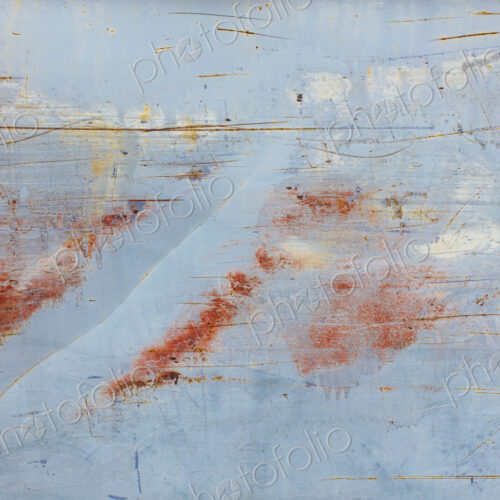 Scratch and rust markings on old metal wall