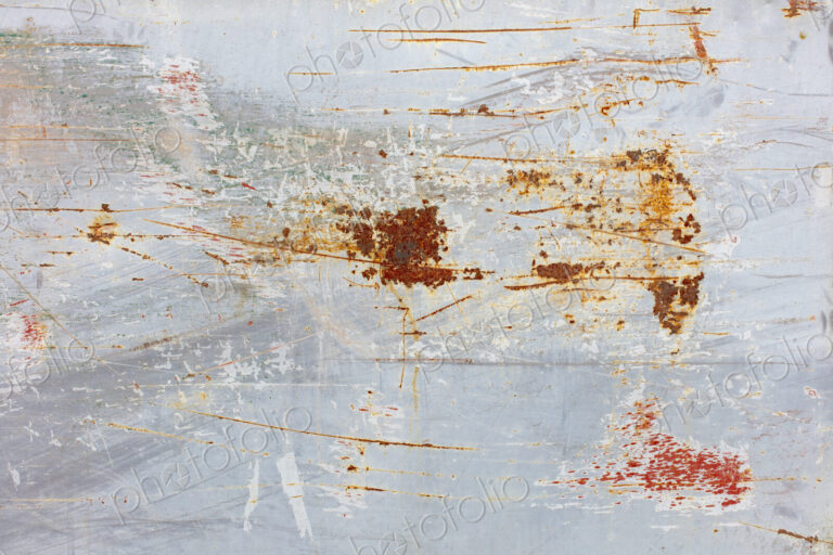 Scratch and rust markings on old metal wall