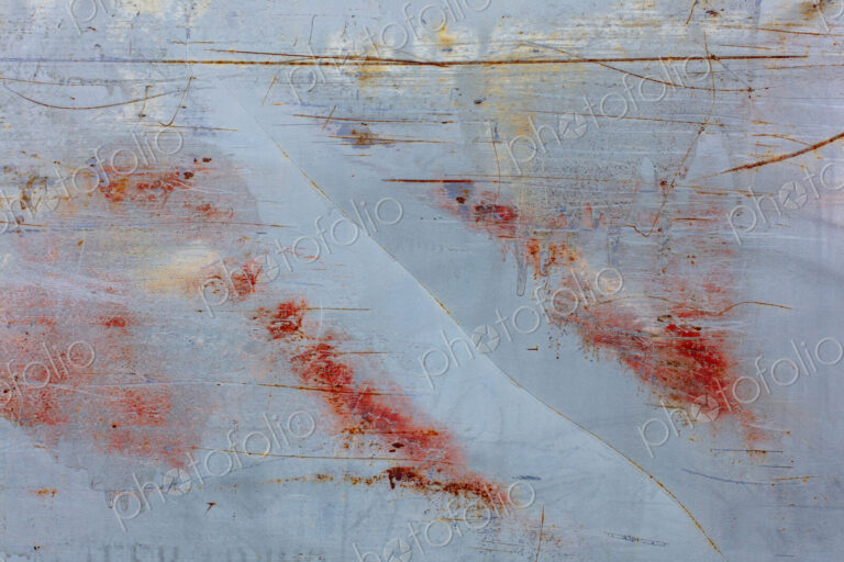 Scratch and rust markings on old metal wall