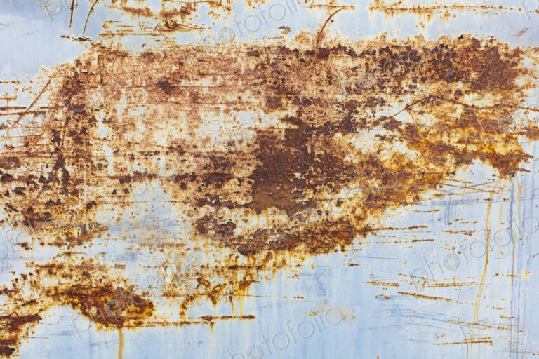 Scratch and rust markings on old metal wall, close up