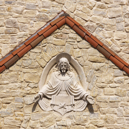 Sculpture of Jesus set into stone wall. Sculpture of Jesus set into stone wall.
