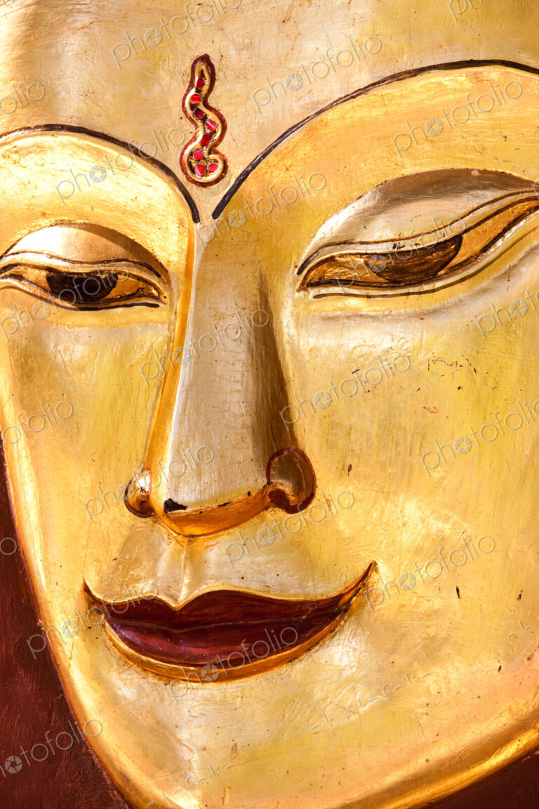Sculpture of a Buddha. Close up of the face, Mandalay, Myanmar