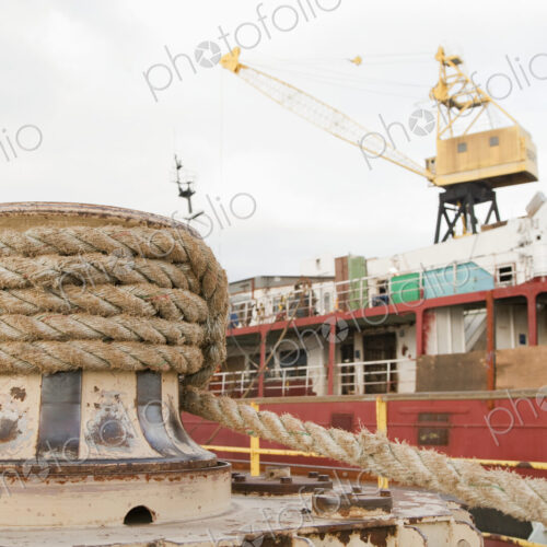 Seaport, dockside, large boat moored, thick ropes