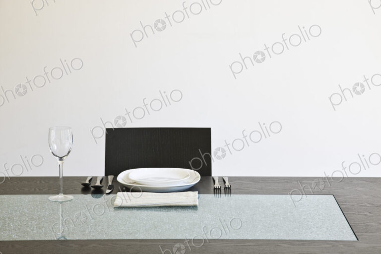 Seat at a dinner table set for a meal.