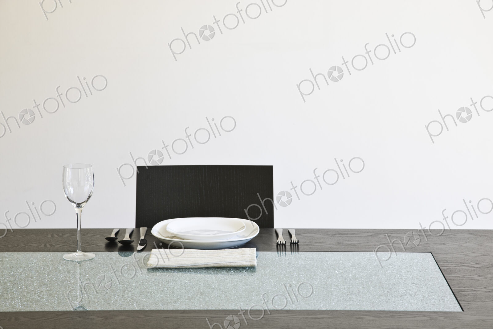 Seat at a dinner table set for a meal.
