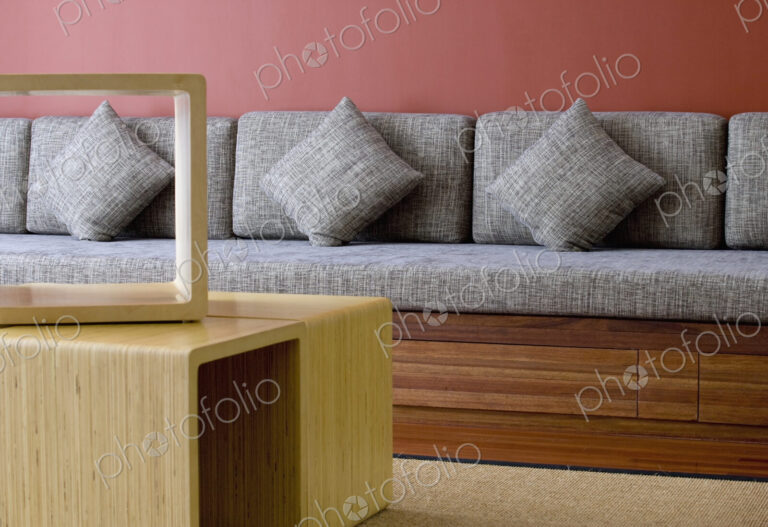 Seating bench with cushions and coffee table.