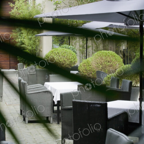 Seating on a paved patio with sun umbrellas
