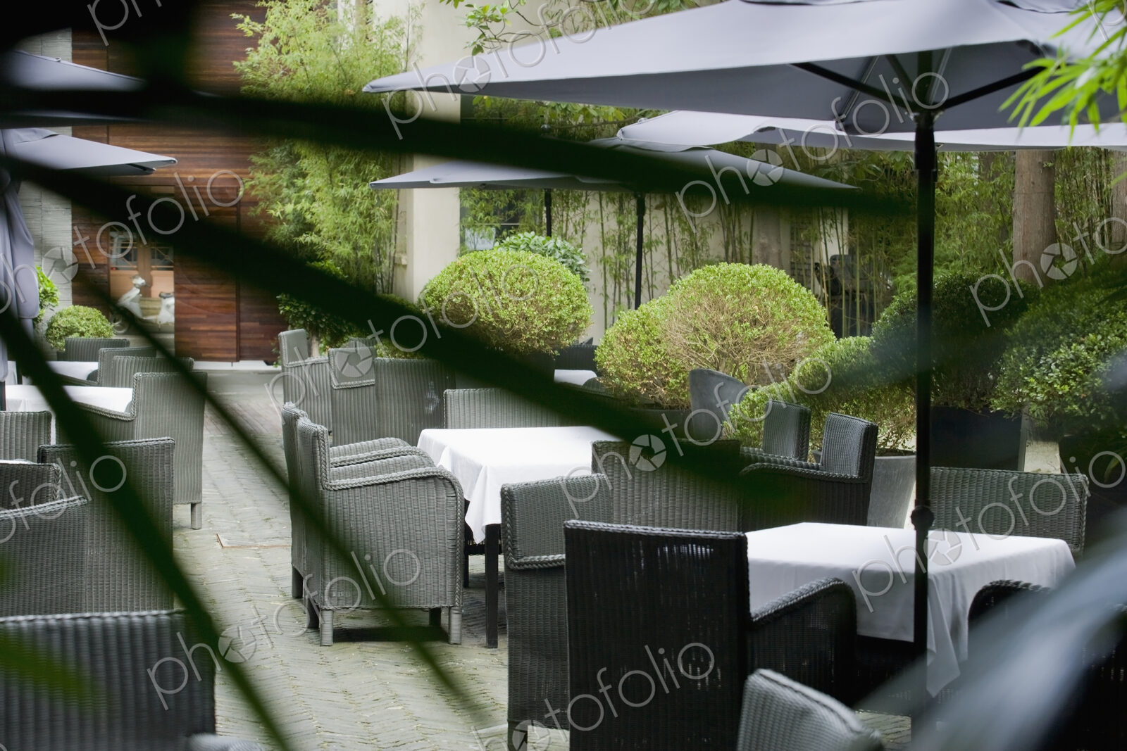 Seating on a paved patio with sun umbrellas