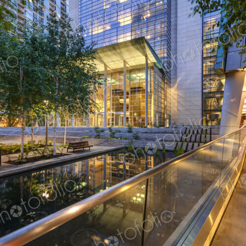 Seattle, a city plaza with modern architecture and water pool at night, lit up. Seattle, a city plaza with modern architecture and water pool at night, lit up.