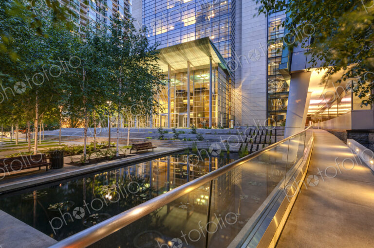 Seattle, a city plaza with modern architecture and water pool at night, lit up.