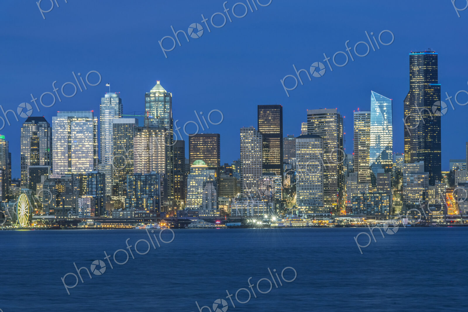 Seattle, the waterfront & skyline of the waterfront and downtown area at dusk.