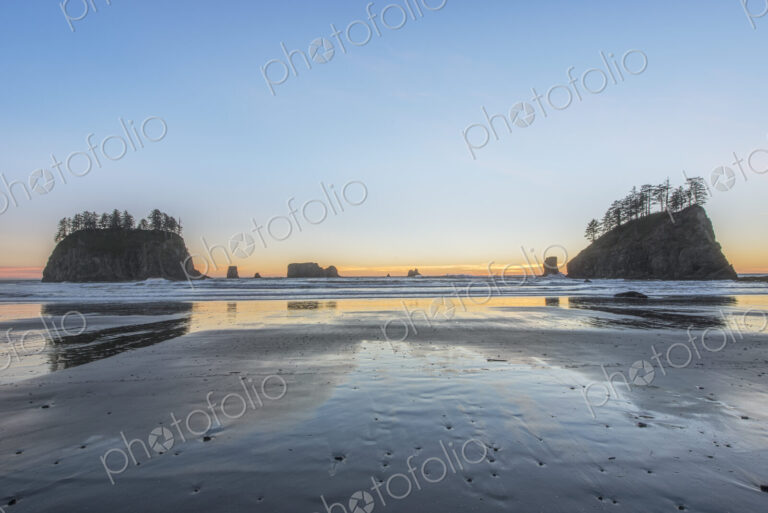 Second Beach at low tide, seastacks offshore silhouetted at sunset.